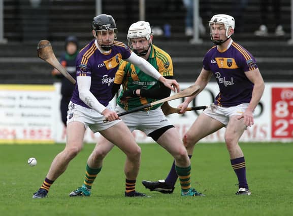 Kilconieron's Sean Burke is outnumbered by Shane Byrne and James Cronin-Rodger of Kinvara during Sunday's county intermediate hurling final at Kenny Park. Photos: Joe O'Shaughnessy.