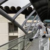 A member of Spain's Military Emergency Unit disinfects handrails in Valencia.