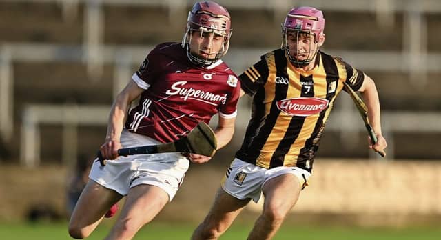 Galway midfielder Michael Burke is chased by Kilkenny's Michael Ahern during Friday evening's Leinster Minor Hurling Final in Portlaoise. Photos: Stephen Marken/Sportsfile