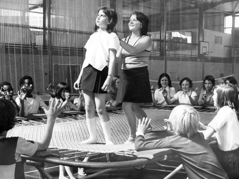 Caroline Broome, from Our Lady of Mercy Convent Grammar School, Wolverhampton, receives instructions on the trampoline from instructor Miss Moira Chadwick at Compton in August 1975. The photograph captures a time when trampolining was a popular activity for young people, with lessons helping pupils build confidence and master new skills. Did you ever have a go at trampolining at school or a local sports centre, and do you remember learning your first moves?