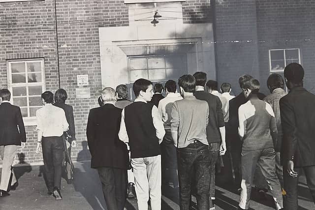 A crowd of young supporters moves toward the entrance of a building in Smethwick on June 3, 1970, ahead of a high-profile general election campaign rally held by Enoch Powell. Photographed from behind, the group local youths headed inside to hear Powell kick off his electioneering trail in the town. The moment captures the intense political atmosphere, youth subcultures, and sharp local debate that defined the run-up to the June 1970 general election across the West Midlands. Do you remember the tense political atmosphere and campaign rallies around the region during the 1970 general election? What are your memories of youth culture and political gatherings in the town back then?