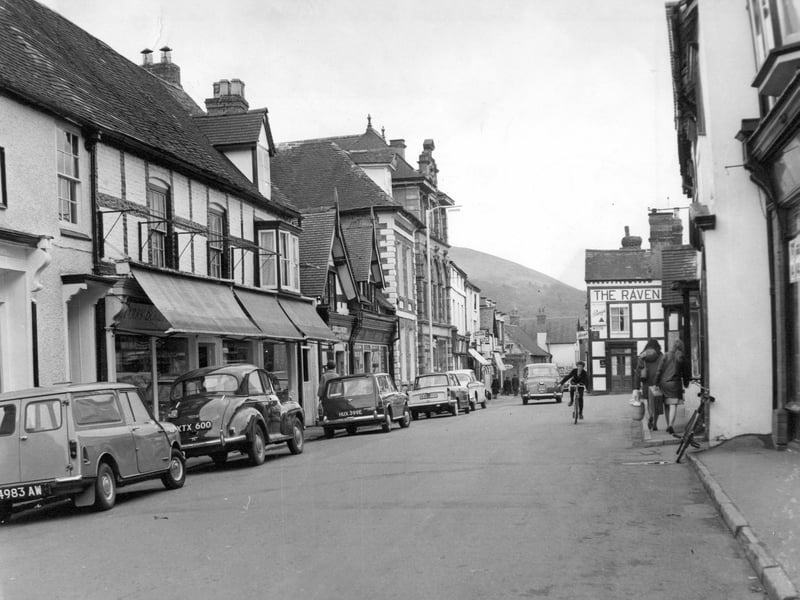 A peaceful scene from Church Stretton High Street in May 1967, when the pace of life seemed a little slower. Parked cars line the street, while a child on a bicycle adds a lovely everyday touch to this snapshot of village life. Do you remember cycling around the town as a child, or the familiar shops and faces that made up the High Street back then?