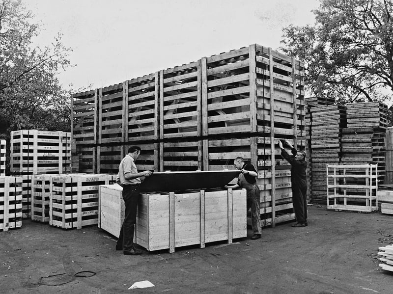 Workers assemble and inspect massive wooden shipping crates at the yard of J Hickman & Son (Brierley Hill) Ltd on October 24, 1970. As manufacturing boomed across the West Midlands, specialised packing firms were called upon to crate up everything from heavy industrial machinery to delicate manufactured goods, preparing them for container transport and long sea voyages overseas. The towering stacks of timber crates ready for shipment reflect the sheer scale of global trade flowing directly out of Black Country factories during the post-war era. Do you remember seeing the busy yards and lorry-loads of timber crates heading out from local industrial estates? Did you or a family member work in the packaging, haulage, or export trade around Brierley Hill back in the 1970s?