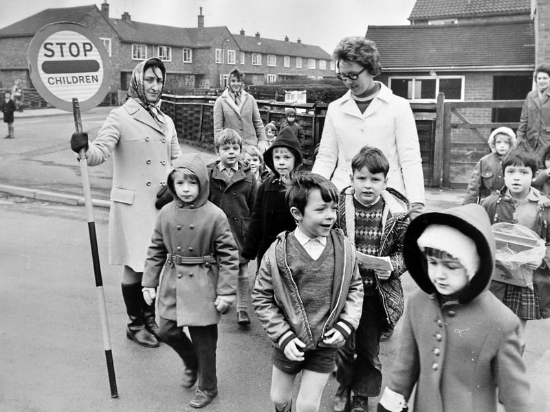 Helping little ones cross the road safely, members of the Tufty Club junior road safety committee stepped in near Oswestry County Infants' School in January 1972 while the regular crossing patrol was off ill. Do you remember the Tufty Club, or being taught road safety at school?