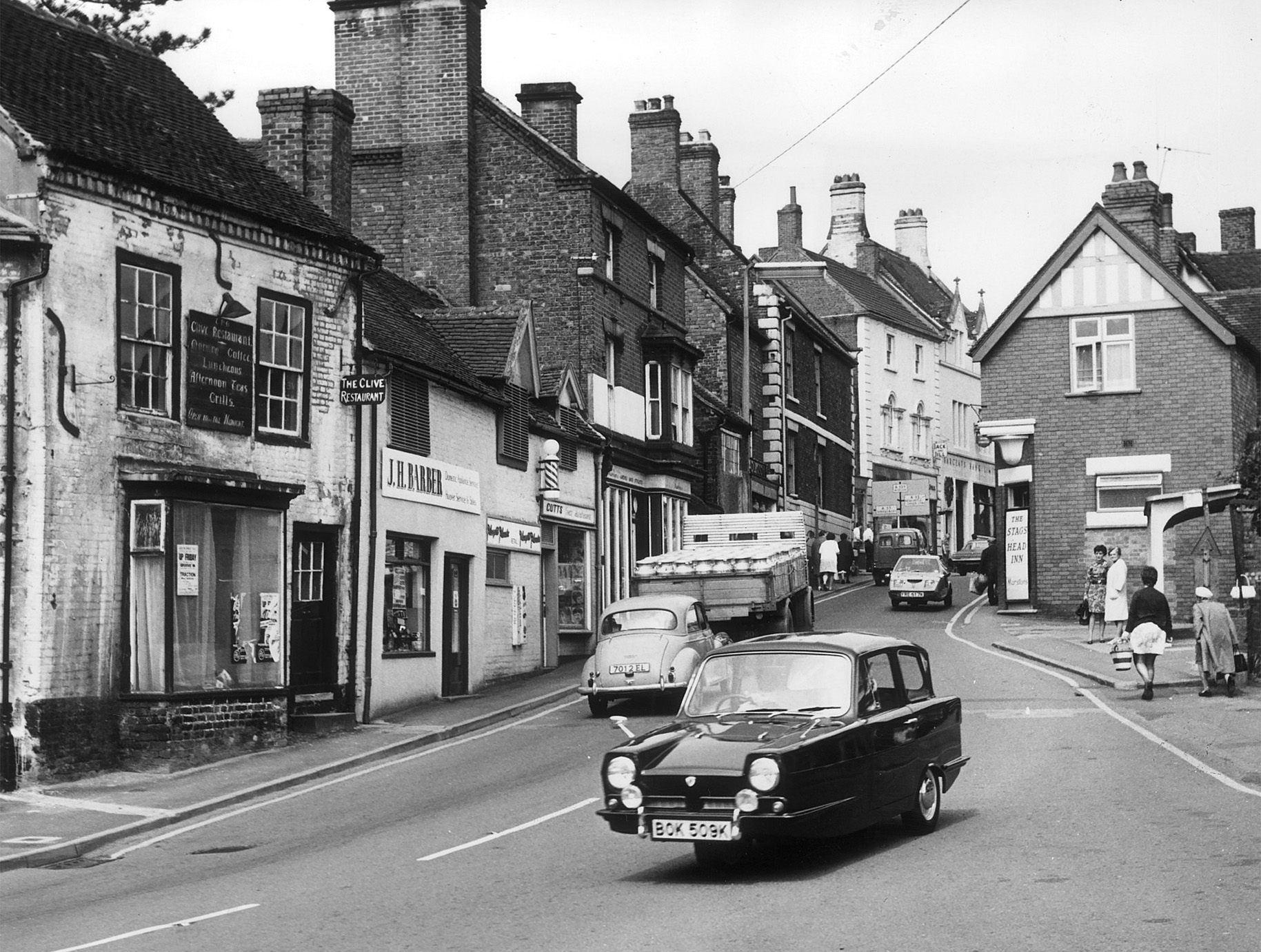 Market day in Market Drayton could mean busy roads in 1972, as this Reliant Regal 21E heads out of town. Do you remember the bustle of shopping days in the town, or can you spot any familiar landmarks that have changed over the years?