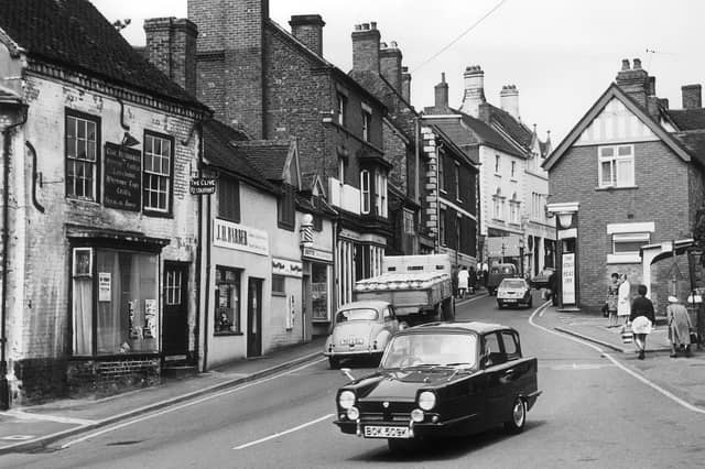 Market day in Market Drayton could mean busy roads in 1972, as this Reliant Regal 21E heads out of town. Do you remember the bustle of shopping days in the town, or can you spot any familiar landmarks that have changed over the years?