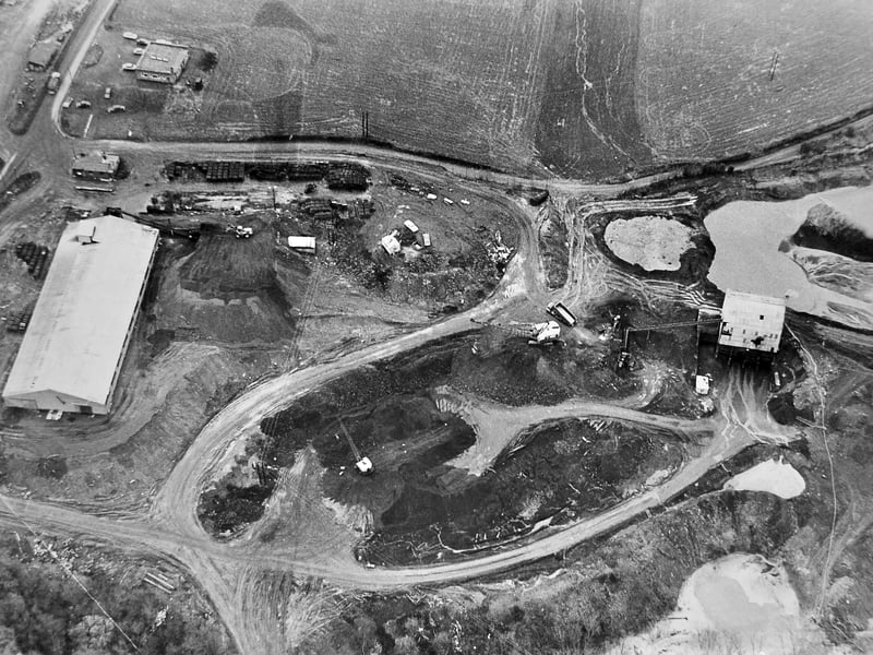 An aerial view captures opencast coal mining at Coalmoor in April 1972, with work taking place at Lydebrook Dingle near the Horsehay to Little Wenlock road. The landscape of Shropshire has changed greatly over the years - do you remember this site being transformed by industry, or watching the work take place?