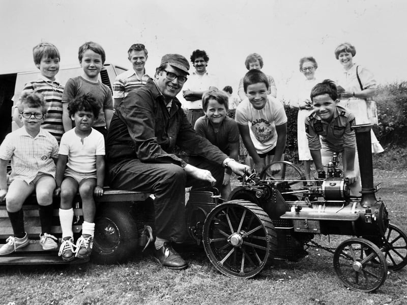 Ray Matthews, of Much Wenlock, delights young visitors and parents alike as he offers rides on his miniature traction engine on July 13, 1985. The charming mini engine proved a huge hit at the traditional summer fete, giving local children a memorable trip around the grounds. Do you recognise any of the happy young passengers lined up for a ride back in the summer of 1985?