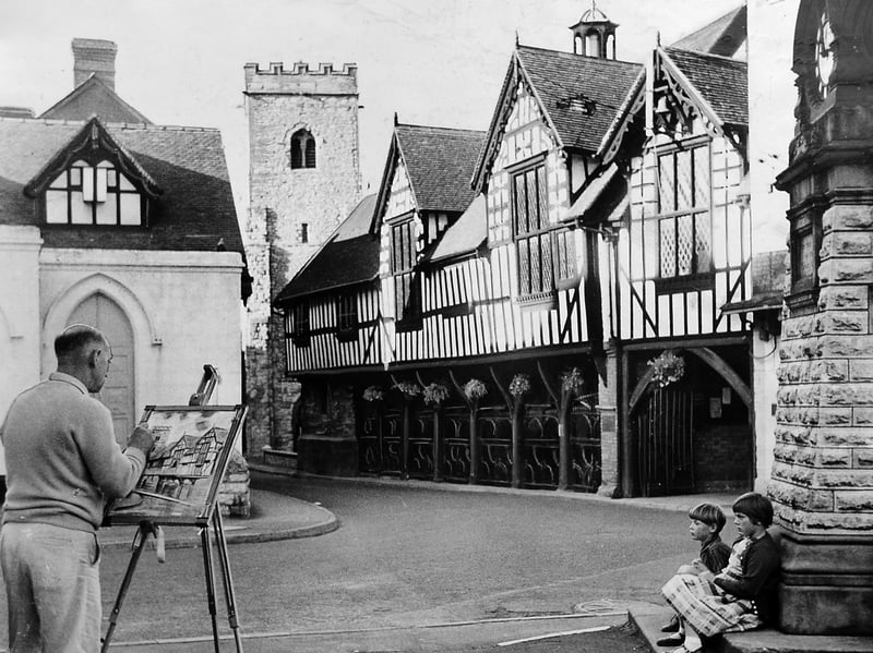 In the long shadows of the late afternoon sun, artist W H C Twist of Newport is pictured painting beside the Old Butter Cross in the centre of Much Wenlock in September 1962. Two young children sit beneath the town clock watching him at work – although one looks rather less impressed than the other! What do you think they made of this unexpected afternoon entertainment? Do you remember seeing artists painting or sketching around Much Wenlock?