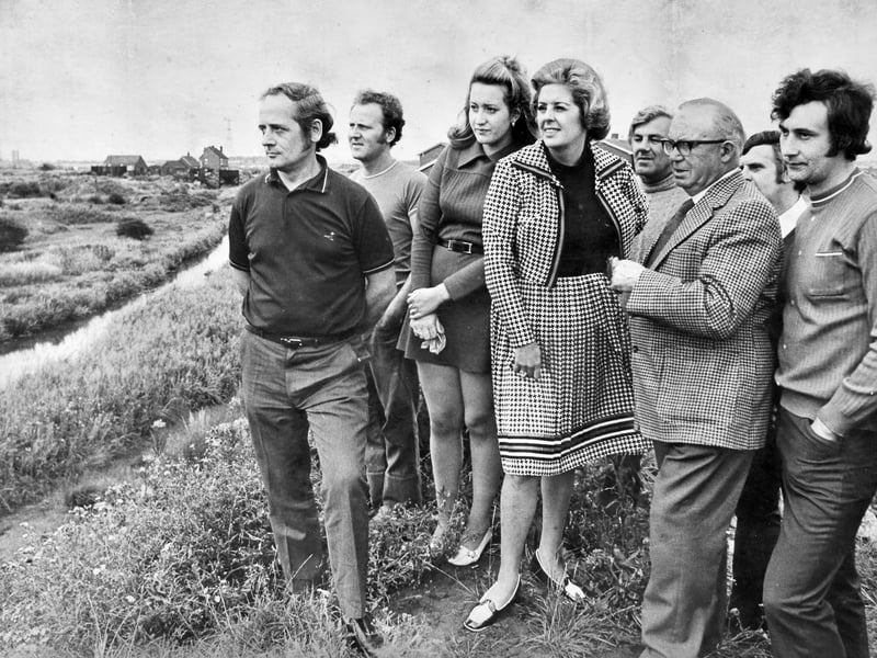 Smartly turned out in a houndstooth checked outfit, West Bromwich West MP Betty Boothroyd surveys the stagnant canal arm at Gospel Oak alongside concerned local residents in August 1974. Families living in the Newman Road area had raised bitter complaints over the foul condition of the waterway running right behind their homes, describing it as an open sewer of raw waste. Following her on-site inspection, the resolute Labour MP pledged to press the Severn Trent Water Authority to stop dragging its heels, get on with the job, and begin urgent clean-up work without delay. Do you remember Betty Boothroyd visiting Newman Road to inspect the canal, or recall living alongside the troubled Gospel Oak waterway back in the summer of 1974?