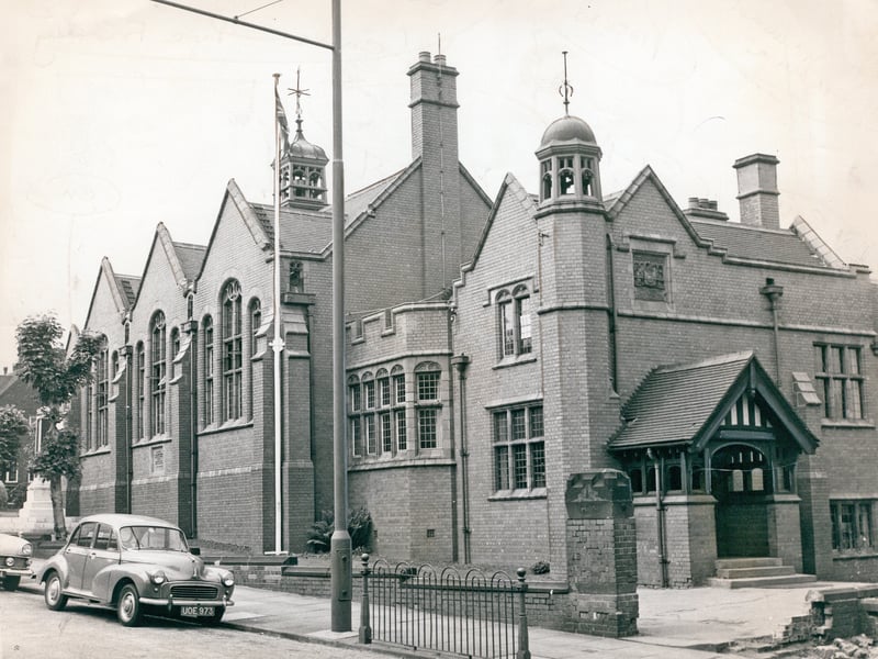 A classic Morris Minor sits parked outside the imposing Victorian facade of Dudley Grammar School on St James's Road in July 1962. First opened in June 1899 to replace older premises in the town, the grand red-brick building featured ornate turrets, large arched windows, and a prominent flagpole flying the Union Jack. The historic school educated generations of local boys before merging to become a comprehensive in 1975, making this quiet summertime snapshot a nostalgic tribute to the town's educational history. Were you a pupil at Dudley Grammar School back in the 1960s, or do you remember the old building on St James's Road?