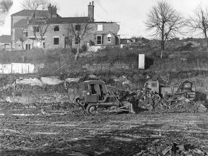 Mechanical diggers churn through mud and rubble as ground clearance gets underway for a major local housing development in December 1962. Brierley Hill Urban District Council kicked off the ambitious Hill Street and Chapel Street redevelopment scheme by clearing older terrace properties to reshape the skyline. The heavy machinery prepared the site for seven planned blocks of flats, including six six-storey buildings and a dominant 13-storey tower block, marking a dramatic shift toward modern post-war housing. Do you remember when these high-rise flats were first built, or do you recall how this area looked before the old streets were cleared?