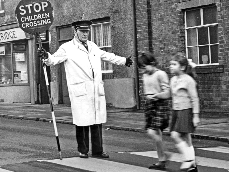 Standing proud with his 'Stop Children Crossing' sign, 75 year old school crossing warden Mr Bill Pitchford guides local schoolchildren safely across the road in December 1962. At the time of the photograph, Mr Pitchford was celebrating an impressive seven year streak without a single accident on his watch. His dedication came amidst a bit of local debate, as some Halesowen wardens found themselves under fire from critics claiming they were over enthusiastic when taking control of passing traffic. Do you remember Mr Pitchford or any of the other lollipop men and women who kept you safe on the school run in the 1960s?