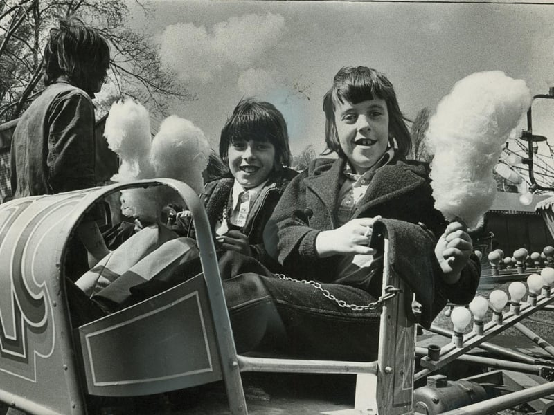 Nine-year-olds Michael Whiteley and Shawn Beech tuck into candyfloss as they enjoy the rides at Pat Collins's fair in Reedswood Park, Walsall, in April 1975. The youngsters, from Three Crowns Special School, were among children treated to a day at the fair by fairground families. Do you remember visiting Pat Collins's fair, and which ride or fairground treat was your favourite?