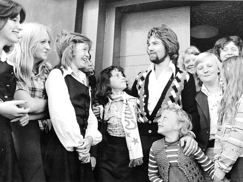 Noel Edmonds poses with fans at Wolverhampton's Club Lafayette in 1975, offering a glimpse of the club's lively social scene. Edmonds would go on to become one of Britain's best-known radio and television presenters, but here he is pictured with fans at the start of his career. Do you remember seeing Noel Edmonds at the Lafayette, or spending a night out at the club in the 1970s?
