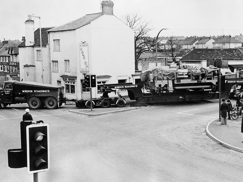 A giant load squeezes through Wellington in 1975. This 96-ton crane section, transported by Wrekin Roadways, passes the Cock Hotel crossroads on its way from Horsehay to Brierley Hill. A familiar sight in the background is H Sutch’s bicycle shop, selling Raleigh bikes. Do you remember this corner of town?