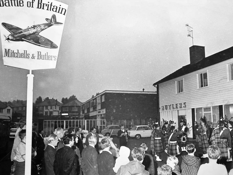 Crowds gather outside the newly refurbished Battle of Britain public house on Birchwood Road on September 15, 1969, to watch a bagpipe band perform at a grand ceremony. Organised by brewery Mitchells & Butlers, the event marked the official reopening of the venue, complete with RAF memorabilia, a "Spitfire Lounge", and historical news clippings. The highlight of the evening came when former 68 Squadron fighter pilot Mr W J Gough, DFC, unveiled the striking new pub sign depicting a Spitfire in a dive, honouring aviation heroes and providing a proud local landmark for the community in Wolverhampton. Did you ever pop in for a drink at the Battle of Britain pub or remember its iconic Spitfire sign in Wolverhampton?