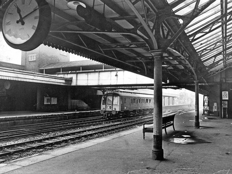 A single diesel multiple unit sits idling at the platform of Wolverhampton Low Level Station on August 12, 1969. The atmospheric view under the grand Victorian ironwork canopy captures a peaceful moment in time, complete with the prominent station clock hanging overhead. As passenger services gradually shifted toward High Level station during this era, quiet scenes like this became increasingly familiar to local commuters travelling through Wolverhampton. Do you have fond memories of catching a train at Wolverhampton Low Level Station before its passenger services came to an end?