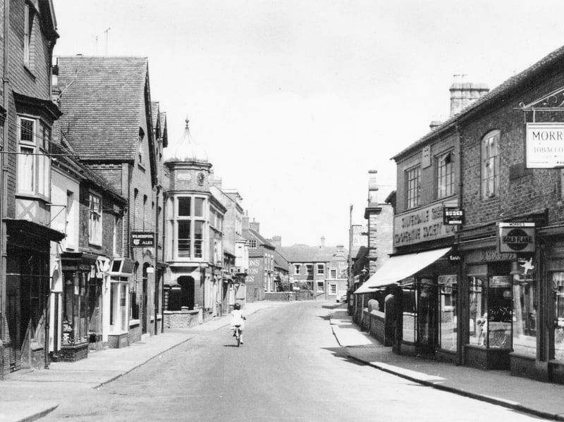 Cheshire Street, Market Drayton, is captured on a real photographic postcard from 1962, in a scene that looks remarkably peaceful compared with the busy street of today. Shared by Dave Francis, the photograph appears to have been taken early in the morning, with just one female cyclist making her way along the road. Look closely and there are plenty of details to spot, from Oakleys agricultural shop and The Oak pub to the domed Town Hall, Morris’s tobacconists, Beresfords cycle shop and the Silverdale Co-operative Society. Can you remember any of these businesses? What else can you spot in this wonderful old view of Cheshire Street?