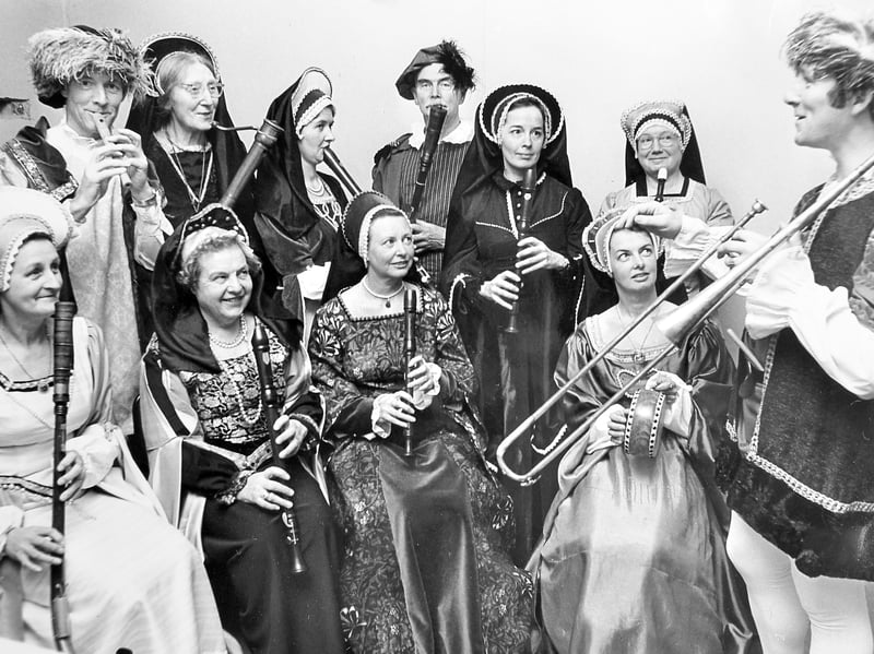 Group leader Richard Duncan and costumed musicians of the Shrewsbury Consort tune historical wind instruments at College Hill House on December 14, 1979, holding final rehearsals before stepping on stage at Shrewsbury Castle for an evening of Tudor-style music. Did you attend the castle concert that December to hear the Shrewsbury Consort play? Do you remember seeing this local group perform around town in their intricate period costumes?