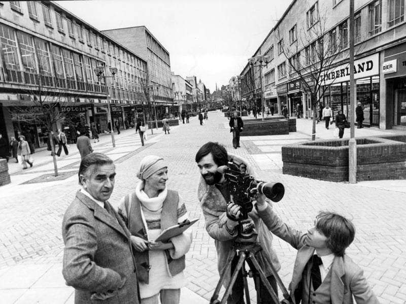 Jim Coulthard (left) and his wife Marie Louise filming on The Moor, Sheffield, for a new city council film in 1980, with shops including Timberland and Dolcis in the background