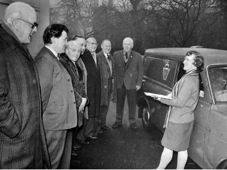 A volunteer coordinator welcomes a line-up of newly recruited male volunteers beside a WRVS delivery van in West Bromwich on February 17, 1976. Long reliant on an established team of 40 women to run the essential local Meals on Wheels service, the West Bromwich branch had grappled with a persistent volunteer shortage until nine public-spirited men stepped forward to help deliver hot meals to elderly and vulnerable residents across the town. Did you ever volunteer for the WRVS Meals on Wheels or receive deliveries from the dedicated crew in West Bromwich back in the 1970s?