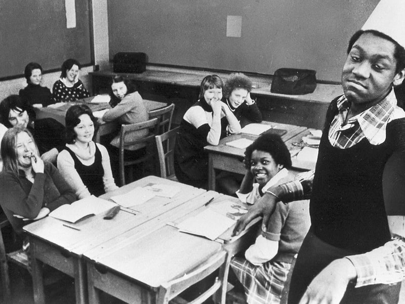 Sporting a makeshift paper fez and striking the comic magician's classic pout, a teenage Lenny Henry has his classroom in stitches at The Bluecoat School in Dudley in 1974. Captured mid-flow during an uncanny Tommy Cooper routine, the naturally gifted young comedian was already honing the comedic timing and mimicry that would soon propel him from schoolroom skits to national stardom on New Faces and Tiswas. Were you one of Lenny's classmates at The Bluecoat School, or do you remember watching him showcase his earliest impressions around Dudley back in 1974?