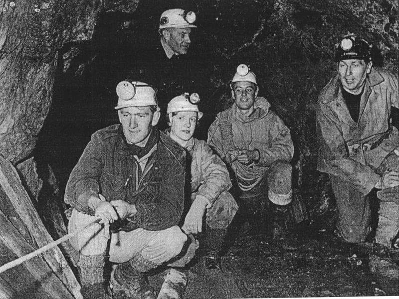 Equipped with helmets and headlamps, members of the Shropshire Mining Club pause deep underground during an expedition at Snailbeach Lead Mine in 1963. Crouched in the foreground from left to right are David Adams, Liz Mason, Mike Gaut, and John Mason, while David Corbyn keeps a watchful eye from the rear. Exploring the vast network of subterranean tunnels and shafts left behind by South Shropshire’s historic lead mining industry, these local enthusiasts helped preserve and document the county’s rich industrial heritage long after the commercial mines had fallen silent. Were you involved with the Shropshire Mining Club during its early 1960s explorations, or do you remember exploring the ancient workings around Snailbeach?
