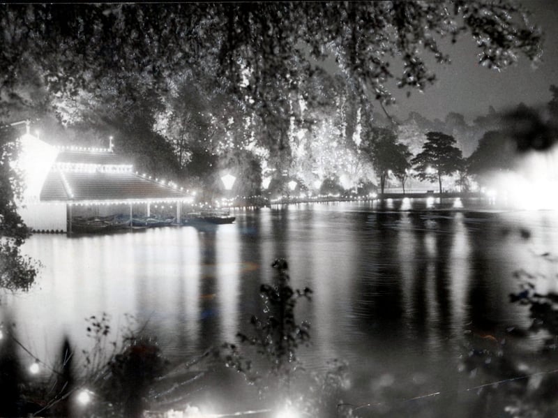 Fairyland illuminations cast shimmering reflections across the water at Walsall Arboretum ahead of the annual autumn event in September 1960. Strings of glowing bulbs line the rustic boathouse roof and surrounding woodland, setting a enchanting scene for thousands of local families drawn to the evening spectacle. A highlight of the town's social calendar, the brilliant light displays transformed the park into a dazzling wonderland every year, creating cherished memories for generations of visitors. Did you ever wrap up warm for an evening stroll through the Walsall Illuminations?