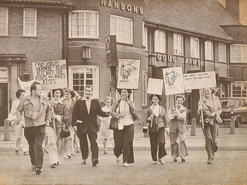 Placard-carrying members of the Hateley Heath Tenants' Association march past the Gough Arms pub in West Bromwich in August 1976 during a campaign against a £1.50 weekly rent increase. Bearing slogans urging neighbours to withhold the rise and depictions of an empty-pocketed elephant, the campaign was soon embroiled in controversy after it emerged secretary Ray Churms was a member of the National Front, prompting calls for his resignation to secure the backing of Sandwell council workers. Do you remember the tenant protests outside the Gough Arms during the summer heatwave of 1976?