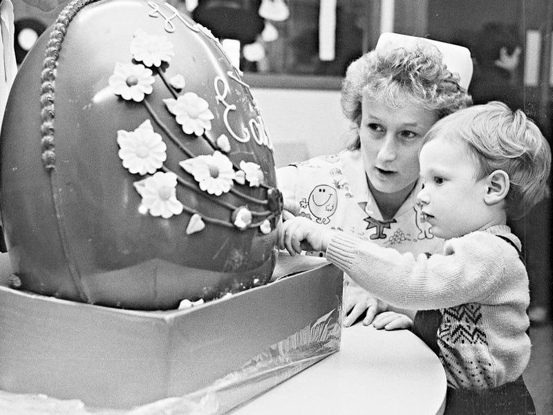Staff from the Dudley branch of Woolworths donated a giant chocolate easter egg to the children's ward at Russells Hall Hospital, Dudley, in 1985. The photograph shows Luke Denley of Grant Close, Kingswinford, with Deborah Shemmans.