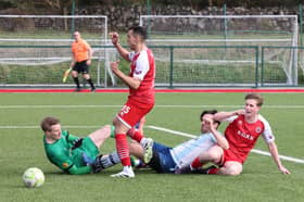 Salthill Devon's goalkeeper Arek Mamala and defender Paul Scally manage to keep out this effort from Colga's Inacio Lopes Jorge and Ben Lalor in their game at the weekend. 
