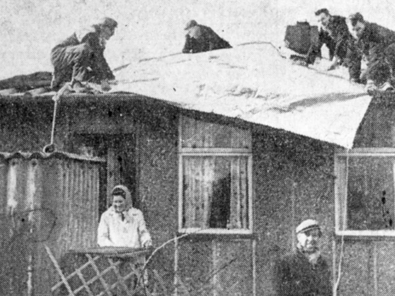 Assessing the damage to Mr D Wilson's house on Skye Edge Avenue, Sheffield, following the gale in February 1962. Part of the roof was ripped away by the gale's intensity.