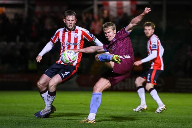 Galway United's Kris Twardek fires goalwards as Derry City captain Jamie Stott looks on.
