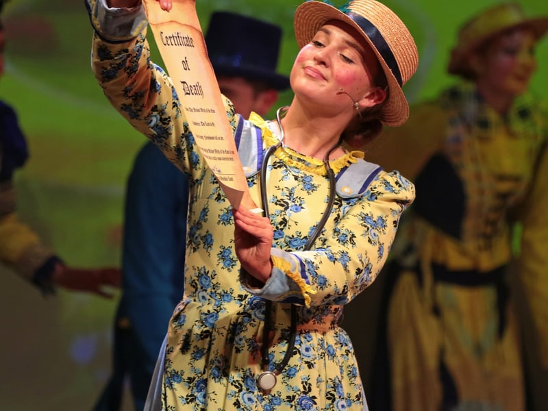 Caption: Munchkin Coroner played by Derfhinn Bushell