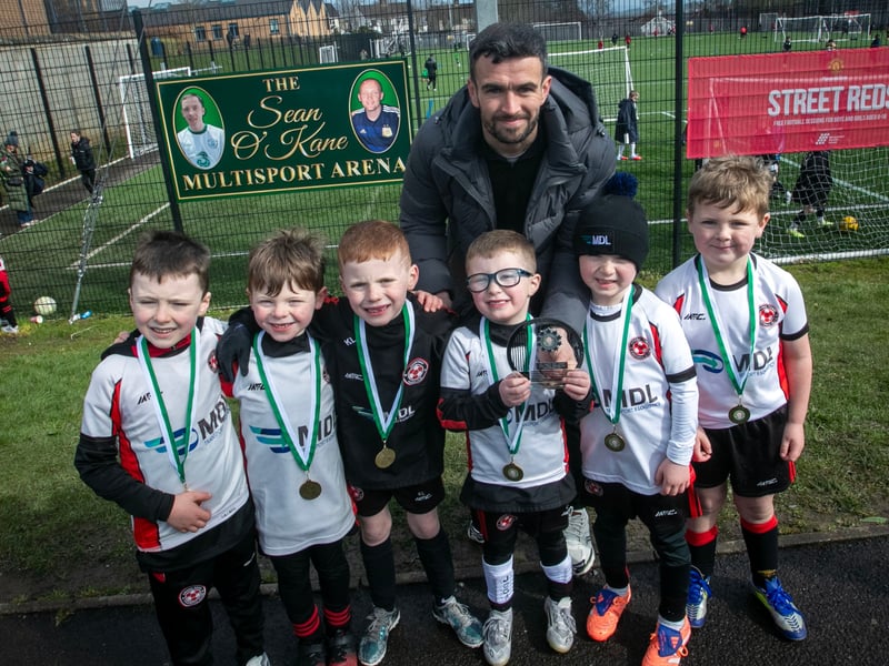 Derry City star Michael Duffy presenting the 2019s Bowl to Omagh Town FC.