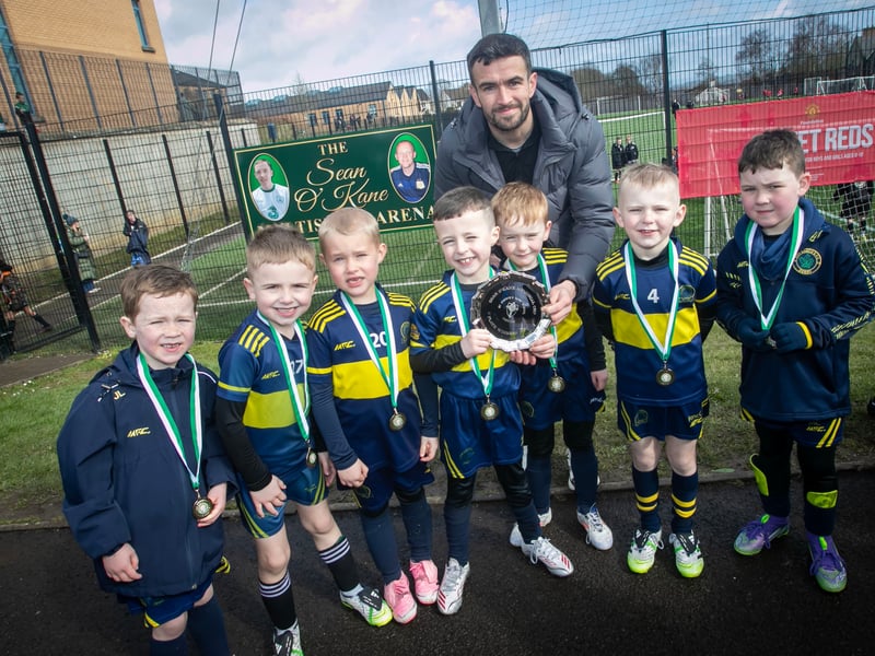 Derry City star Michael Duffy presenting the 2019s Plate to Don Bosco FC.