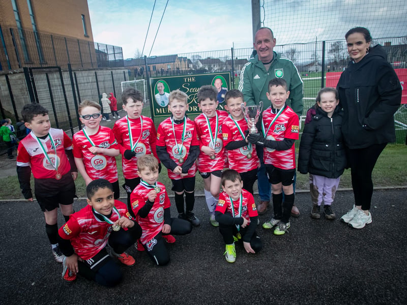 Mr. Feargal O'Kane presents the 2018s Sean O'Kane Cup to winners Maiden City Soccer on Sunday morning. Included are Eireann and Emerald O'Kane.