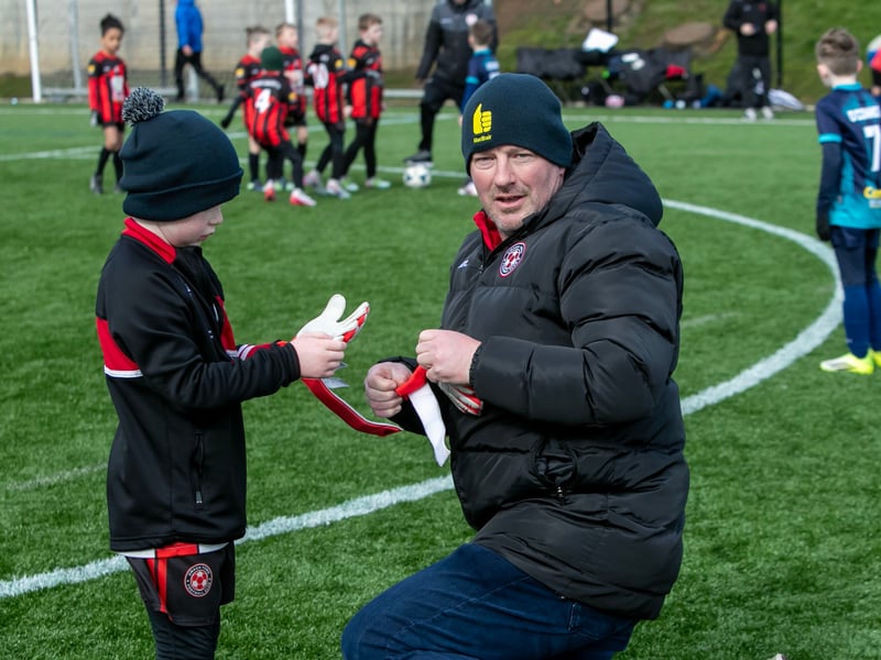 The Omagh Town keeper gets a new pair of gloves.