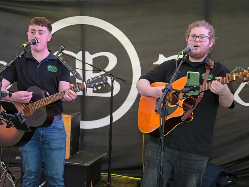 Caption: Dominic and John of Creva on stage in the entertainment tent