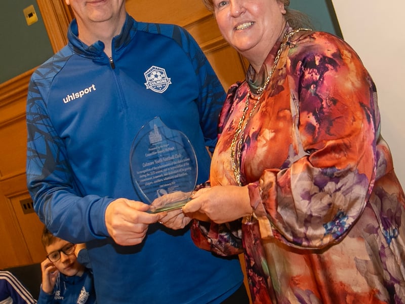 Culmore Youths FC chairman Ben Dooher receiving a presentation from the Deputy Mayor, Niree McMorris to mark the achievements of the club during the 2025 season, during a reception in the Guldhall on Tuesday evening.