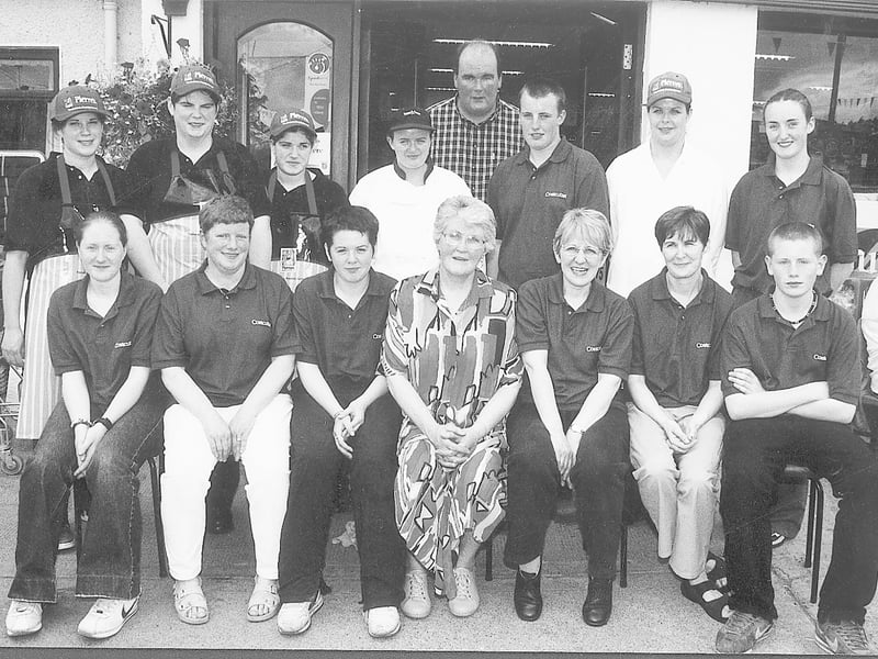 Caption: James O'Flaherty is pictured with staff members at the official opening of his new supermarket