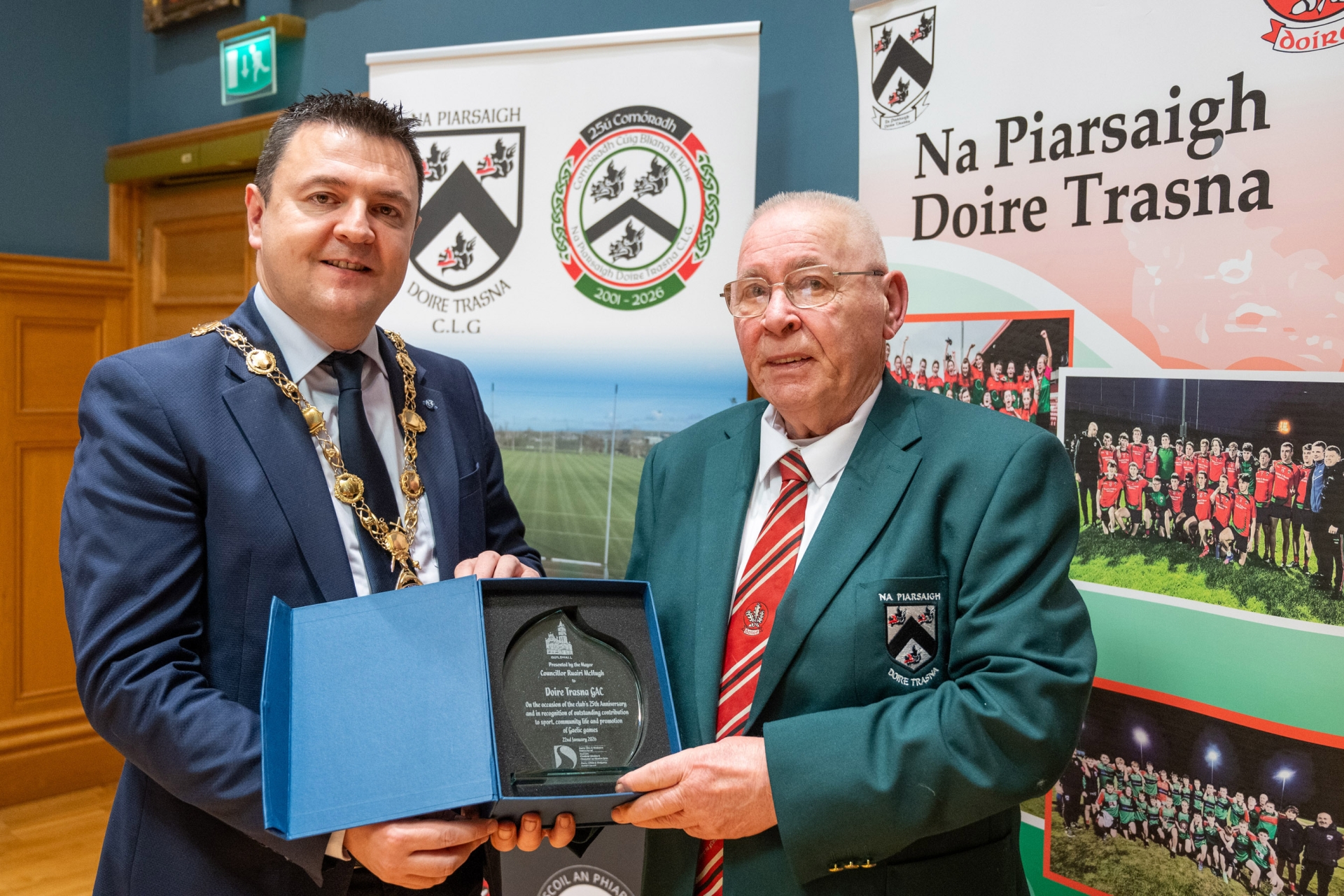Mayor of Derry City and Strabane District Council, Councillor Ruairí McHugh, has hosted a civic reception for players, officials and volunteers of Na Piarsaigh Doire Trasna GAA Club to celebrate the Waterside club’s 25th anniversary. The club’s thriving underage set up were well represented at the event in the Guildhall’s Whitaker suite and they provided musical and dancing entertainment for those in attendance.Mayor McHugh made a presentation to Club President Eddie Nash to mark the milestone and commended everyone involved in growing the club over the last 25 years. “It was a genuine honour for me to spend the evening with members of CLG Doire Trasna and recognise the outstanding contribution the club has made to sport, community life and the promotion of gaelic games in the Waterside,” said Mayor McHugh.“From humble beginnings the club now have a state of the art home on Corrody Road and enjoy huge participation numbers from under age right up to senior level where their League and Junior Championship double of 2017 was a highlight. “The entertainment provided by the club’s underage members on the night shows that their activities stretch far beyond the gaelic pitch and it was clear to me that this is a thriving club, rooted in their community who I am certain will go from strength to strength in the years ahead.” PICTURED BELOW: Doire Trasna GAC who are celebrating their 25th Anniversary received a commemorative crystal gift from the Mayor Councillor Ruairi McHugh in the Guildhall to mark their outstanding contribution to sport, community life and promotion of Gaelic games. During the evening the club’s traditional band and Irish dancers entertained guest with performances. The award was received by club President, Eddie Nash. (Photos: Martin McKeown) We want your photos to feature on the website via our Camera Club. Do you have a great photo from life in the locality? Whether it’s a party, wedding, communion, landscape, a quirky shot from your archives, or a simple everyday