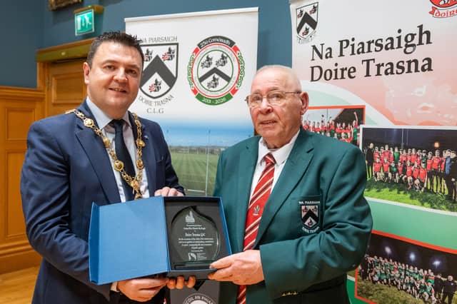 Mayor of Derry City and Strabane District Council, Councillor Ruairí McHugh, has hosted a civic reception for players, officials and volunteers of Na Piarsaigh Doire Trasna GAA Club to celebrate the Waterside club’s 25th anniversary. The club’s thriving underage set up were well represented at the event in the Guildhall’s Whitaker suite and they provided musical and dancing entertainment for those in attendance.Mayor McHugh made a presentation to Club President Eddie Nash to mark the milestone and commended everyone involved in growing the club over the last 25 years. “It was a genuine honour for me to spend the evening with members of CLG Doire Trasna and recognise the outstanding contribution the club has made to sport, community life and the promotion of gaelic games in the Waterside,” said Mayor McHugh.“From humble beginnings the club now have a state of the art home on Corrody Road and enjoy huge participation numbers from under age right up to senior level where their League and Junior Championship double of 2017 was a highlight. “The entertainment provided by the club’s underage members on the night shows that their activities stretch far beyond the gaelic pitch and it was clear to me that this is a thriving club, rooted in their community who I am certain will go from strength to strength in the years ahead.” PICTURED BELOW: Doire Trasna GAC who are celebrating their 25th Anniversary received a commemorative crystal gift from the Mayor Councillor Ruairi McHugh in the Guildhall to mark their outstanding contribution to sport, community life and promotion of Gaelic games. During the evening the club’s traditional band and Irish dancers entertained guest with performances. The award was received by club President, Eddie Nash. (Photos: Martin McKeown) We want your photos to feature on the website via our Camera Club. Do you have a great photo from life in the locality? Whether it’s a party, wedding, communion, landscape, a quirky shot from your archives, or a simple everyday