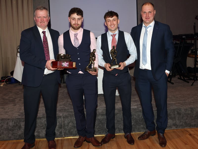 CAPTION: Chairperson Tommy Hawes and team manager Niall Vance present the John Moran Memorial trophy to joint player of the year winners John Hand and Niall Nerney