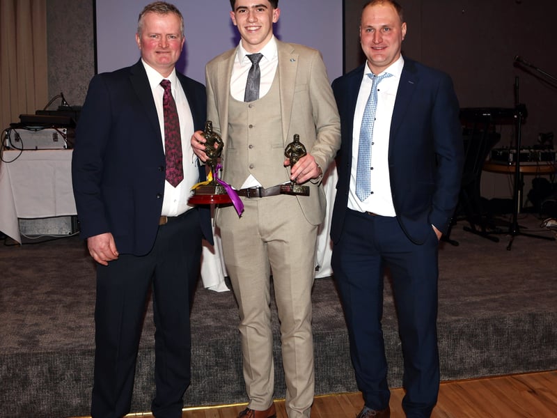 CAPTION: Chairperson Tommy Hawes and team manager Niall Vance present the Brendan Lennon Memorial trophy to Beau O'Connor, the Young Player of the year award winner