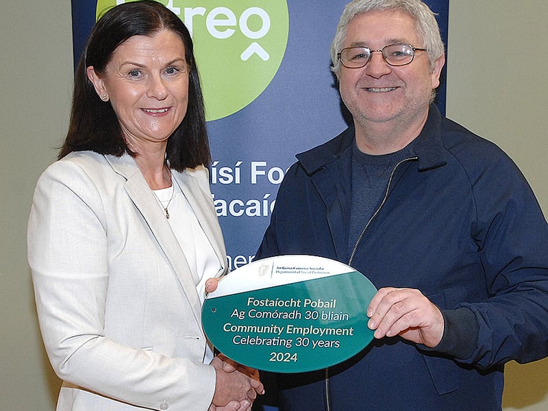 Below: Noeleen Mallon of the DSP presenting a plaque to Brian Core of the Fane Community Scheme 