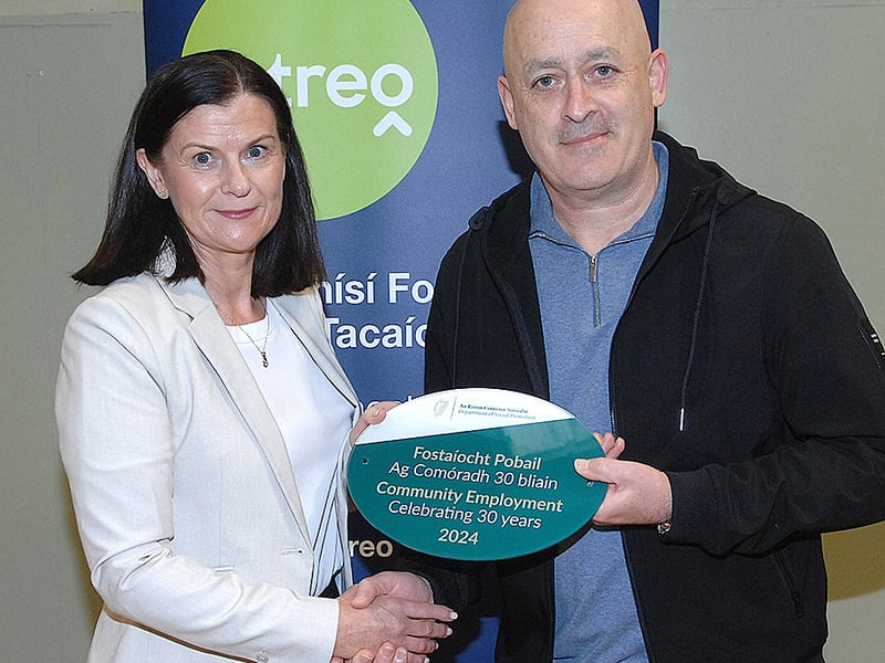 Below: Maureen Mallon presenting Tommy Reilly of the Mid Louth Scheme with a plaque