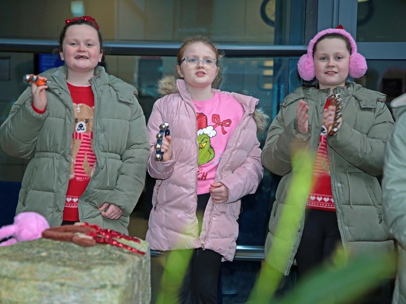 Caption: Students playing bells as percussion for the carols