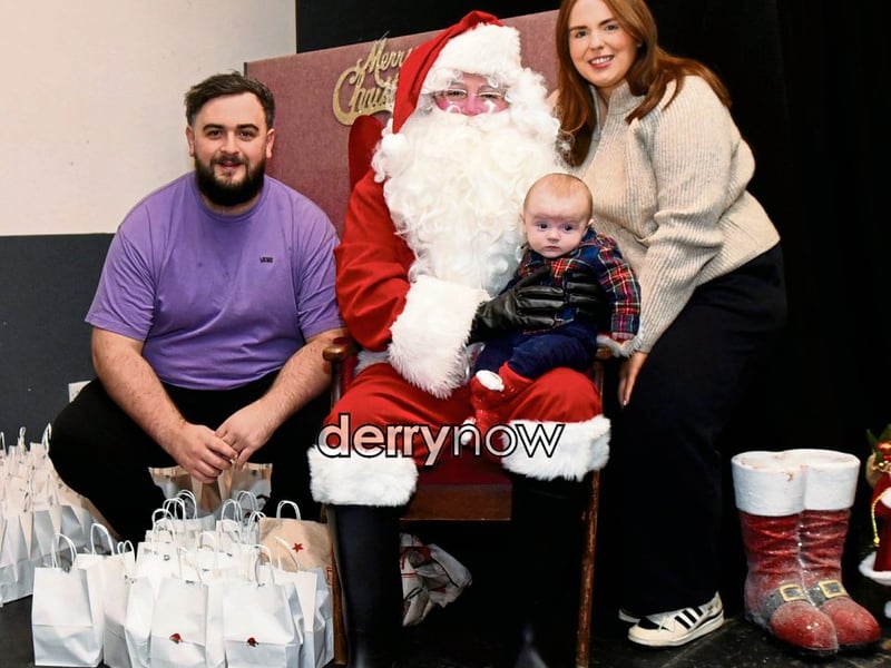 Tadhg and his parents Connor and Emer enjoy Breakfast with Santa in An Cumann, Dungiven.